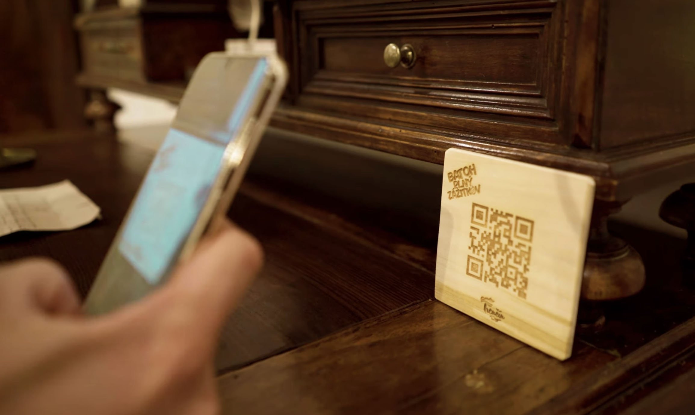 Detail na moderný smartfón skenujúci QR kód v lese